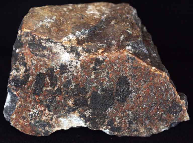 Colour image of brown rock with black, white and gray spots